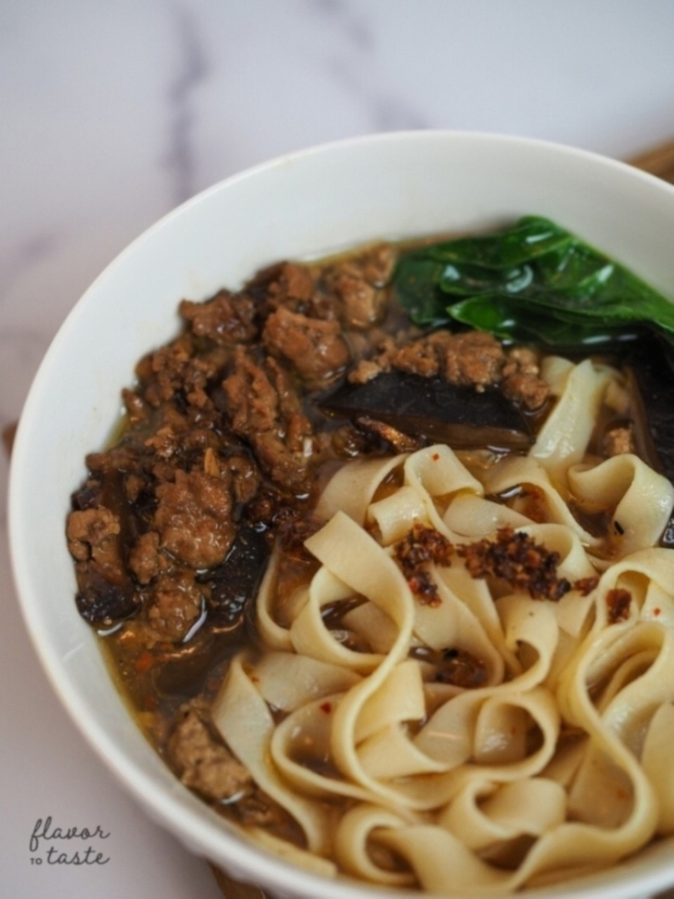 Hot bowl of Hakka board noddles with minced pork and greens