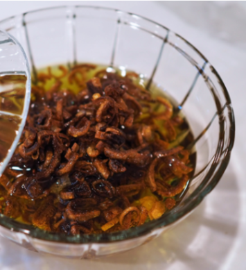 Shallot oil with golden-brown fried shallots in a crystal bowl